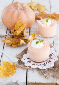 Pumpkin mousse,decorated with mint leaves and whipped cream in a glass beaker.selective focus