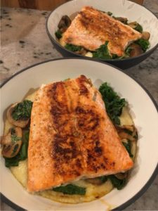salmon with veggies over cheesy grits